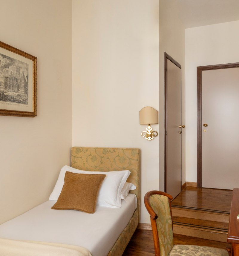 Cozy single room at Hotel Cortina in Rome, classically furnished with a single bed and wooden desk. - Hotel Cortina, BZAR hotels in Rome